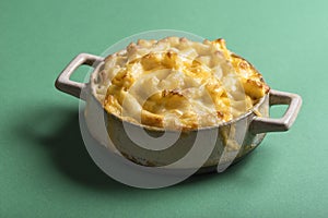 Baked mac and cheese in a clay tray. Macaroni with melted cheese