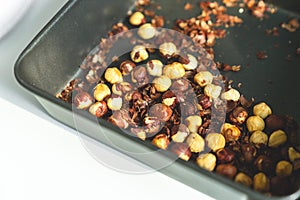 baked macadamia in metal tray, close up, with copy space