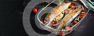 Baked mackerel with herbs and lemon and vegetables.