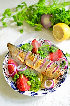 Baked mackerel with lemon, onion, herbs