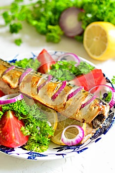 Baked mackerel with lemon, onion, herbs