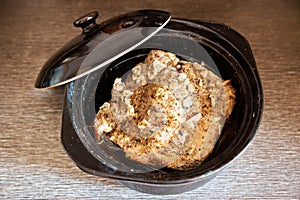 Baked meat in a ceramic pan. Close-up. View from above photo