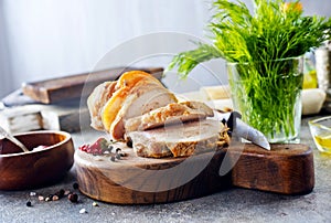 baked meat roll with spice on wooden board