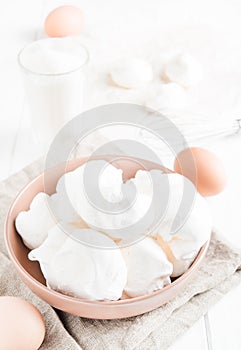 Baked meringue with ingredients on white background