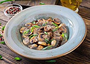 Baked mushrooms with soy sauce and herbs. Vegan food.