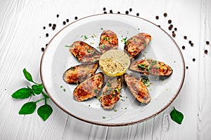 Baked mussels with cheese on plate