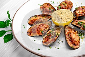 Baked mussels with cheese on plate