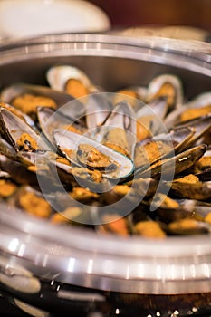 Shellfish baked mussels with herbs and white wine cooked in pot