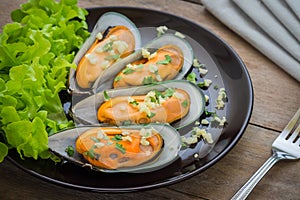 Baked mussels with garlic on plate