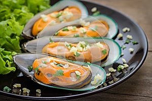 Baked mussels with garlic on plate