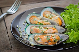 Baked mussels with garlic on plate