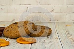 Baked oatmeal cookies and bagel lie on a light wooden table. There is a place for text. Concept breakfast, holiday, cooking