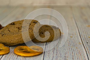 Baked oatmeal cookies and bagel lie on a light wooden table. There is a place for text. Concept breakfast, holiday, cooking