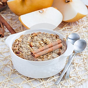Baked oatmeal with nuts, almond milk, honey, spices and asian pear, square format