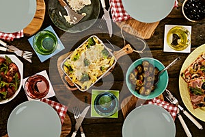 Baked pasta, pizza and salad on table