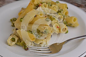 Baked pasta with zucchini peas cream cheese italian dish