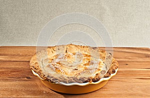 Baked peach pie a yellow ceramic pie pan