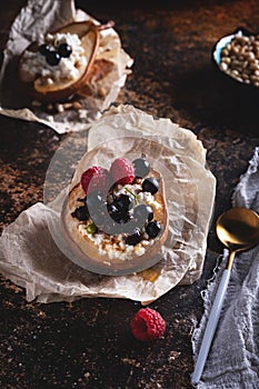 Baked pear with honey, cottage cheese, raspberries and currants. Fresh homemade dessert. Food composition in a low key. Close-up,