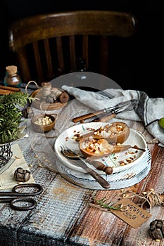 Baked pears cut in half with ricotta, granola, pine nuts on ceramic plate