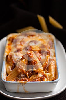 Baked penne pasta with tomato sauce and cheese