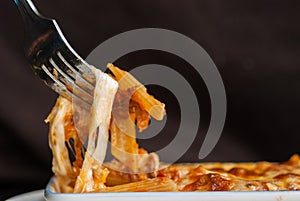 Baked penne pasta with tomato sauce and cheese