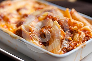 Baked penne pasta with tomato sauce and cheese