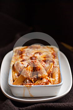 Baked penne pasta with tomato sauce and cheese