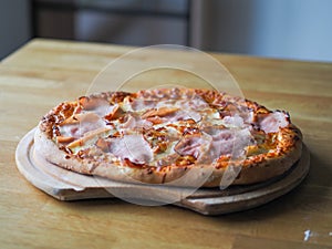 baked pizza with cheese, ham and sauce