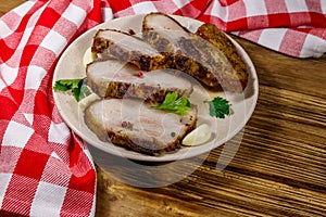 Baked pork belly in plate on wooden table