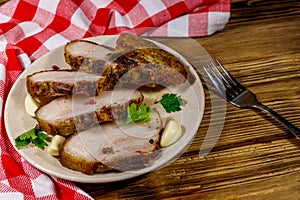 Baked pork belly in a plate on wooden table