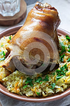 Baked pork knuckle served with stewed cabbage and beer. Rustic style