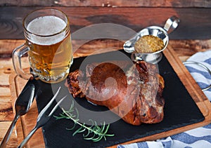 Baked pork shank, rosemary branch and honey sause and glass of b