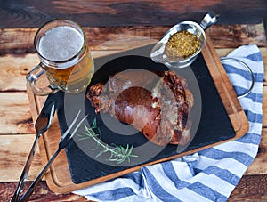 Baked pork shank, rosemary branch and honey sause and glass of b