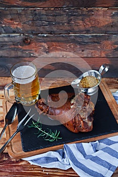 Baked pork shank, rosemary branch and honey sause and glass of b