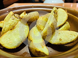 Baked potato chips dipped in tomato sauce