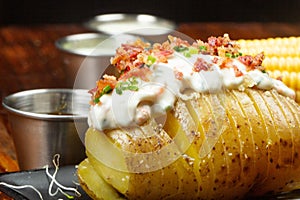 Baked potato with cream cheese, bacon and chive topping
