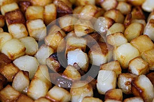 baked potato cubes in pan in kitchen