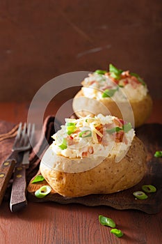 Baked potato in jacket with bacon and cheese