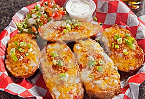 Baked potato skins topped with cheese and bacon