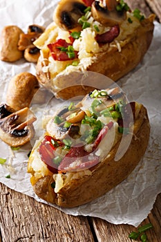 Baked potato stuffed with bacon, mushrooms and cheese close-up.