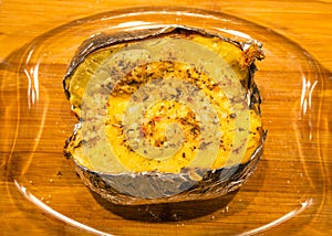 Baked potatoe in foil with sour cream