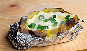 Baked Potatoes with Cheese and Bacon Served on Wooden Table