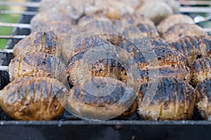 baked potatoes on the coals on the grill with a Golden crust. food preparation