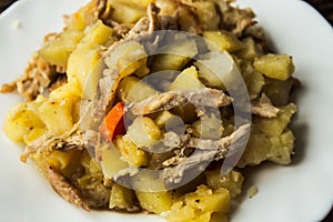 Baked potatoes with meat, carrots and onions