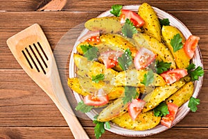 Baked potatoes in a peel with tomatoes, herbs, spices and sesame