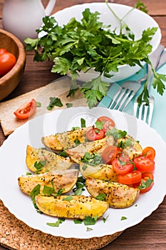 Baked potatoes with ripe tomatoes and fresh herbs