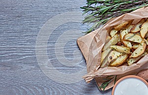 Baked potatoes with rosemary on a gray background