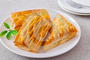 Baked puff pastry on white plate