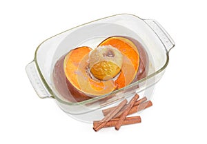 Baked pumpkin and apple in glass casserole pan and cinnamon