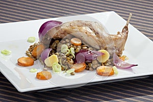 Baked rabbit leg with lentil and vegetable